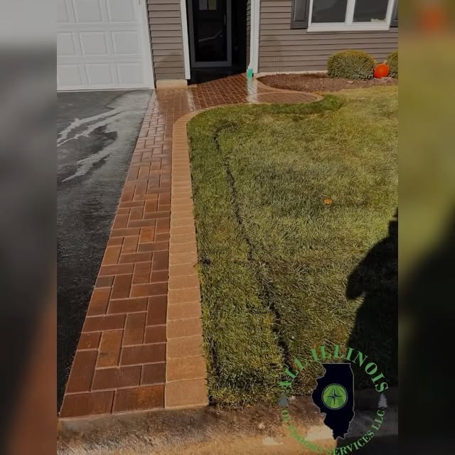 Brick front walkway connecting a home entrance and driveway