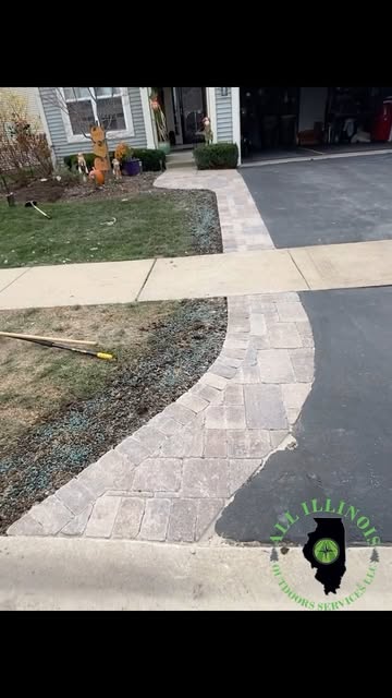 Curved paver walkway alongside a driveway