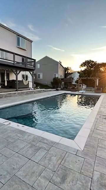 Paved poolside outdoor space shared on the company Instagram page