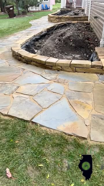 Flagstone walkway and a curved stone planting-bed border